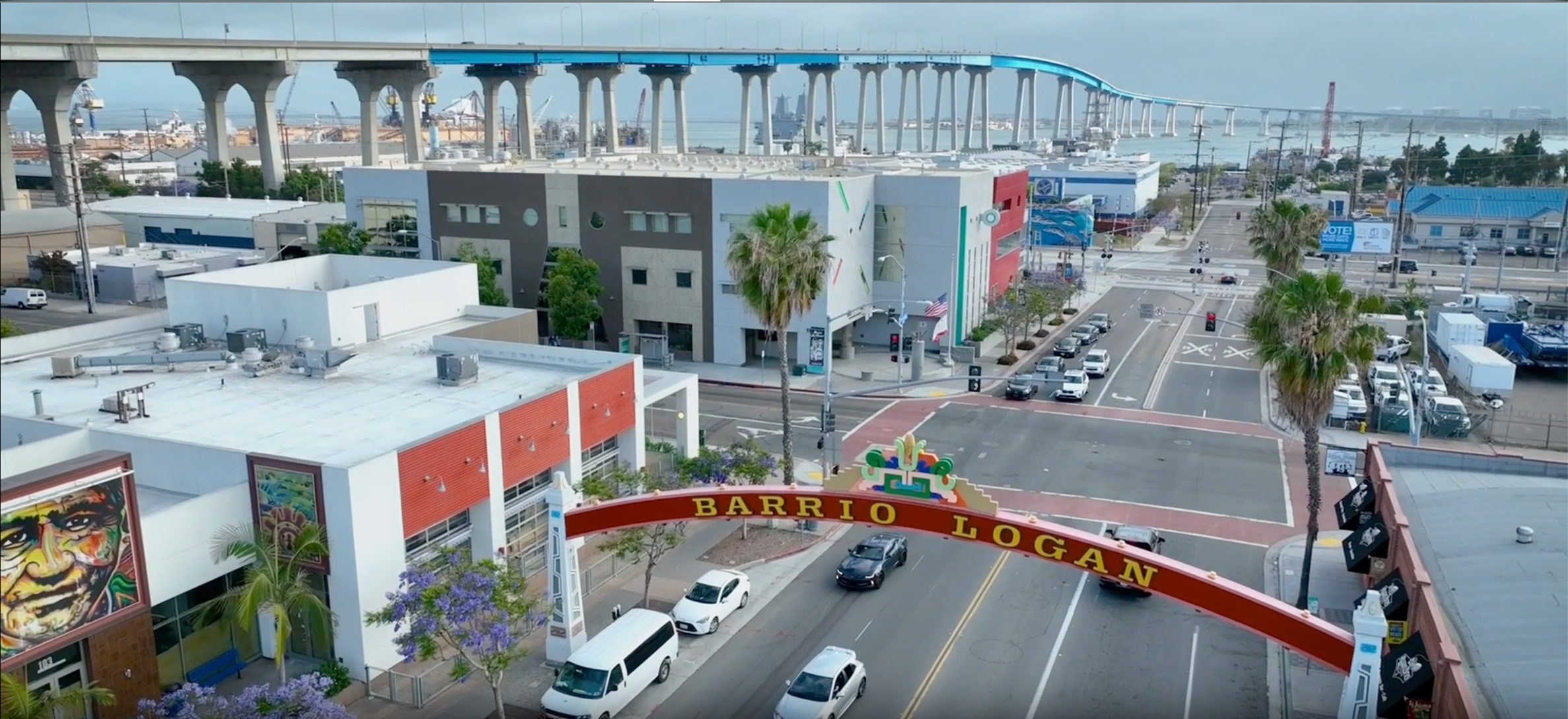 Barrio Logan streetscape with the neighborhood archway over the street.